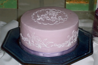 Single tier fondant wedding cake decorated with a floral royal icing stencil.
Hillsborough, NC