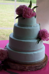 Smooth fondant wedding cake decorated with bright peonies.
Durham, NC